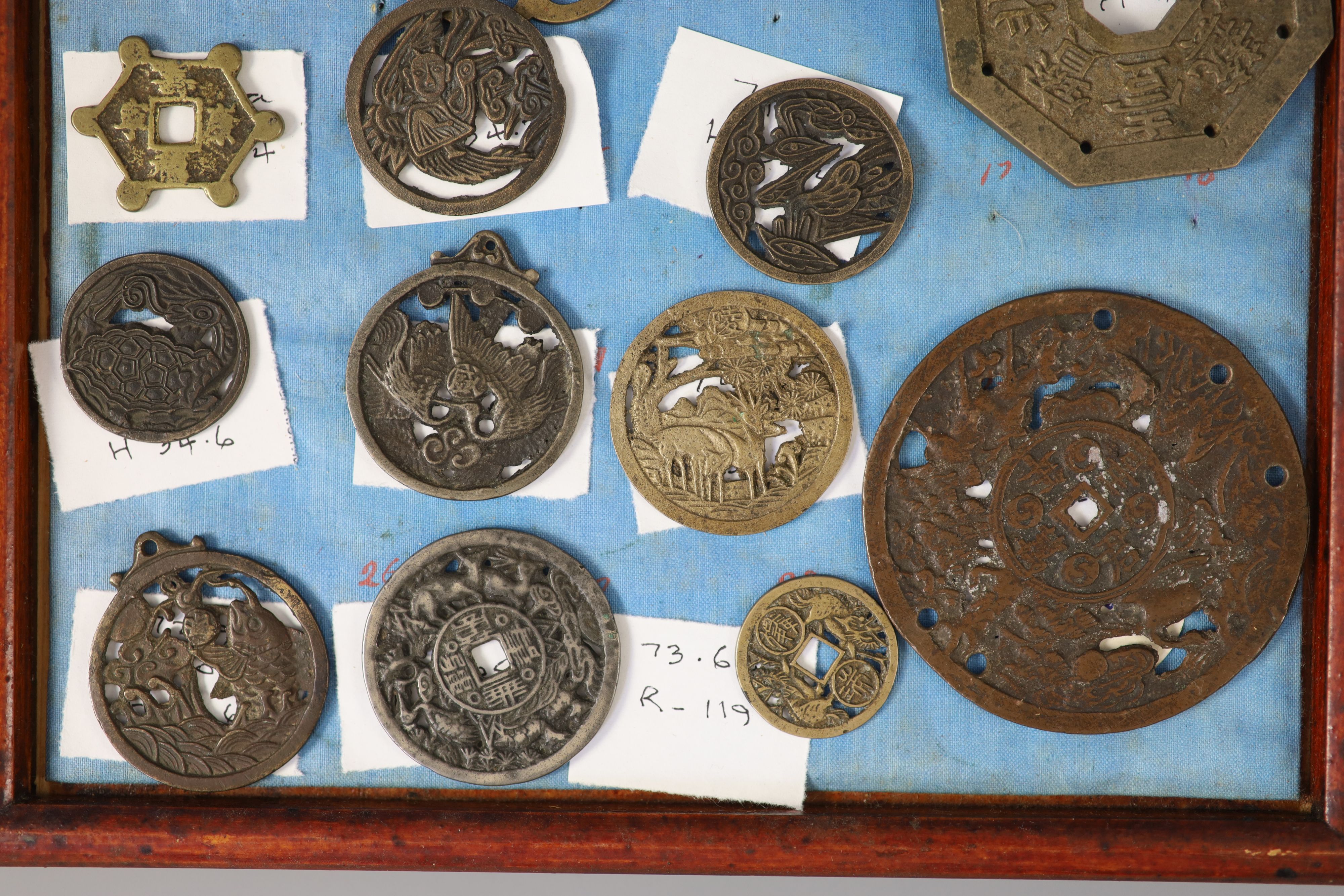 A group of 99 Korean bronze and metal amulets or charms, 19th/20th century
